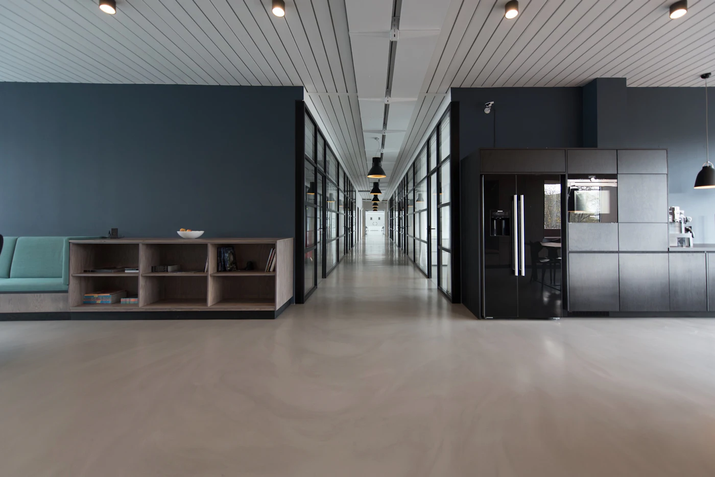 Commercial office corridor with glass partitions and polished floors
