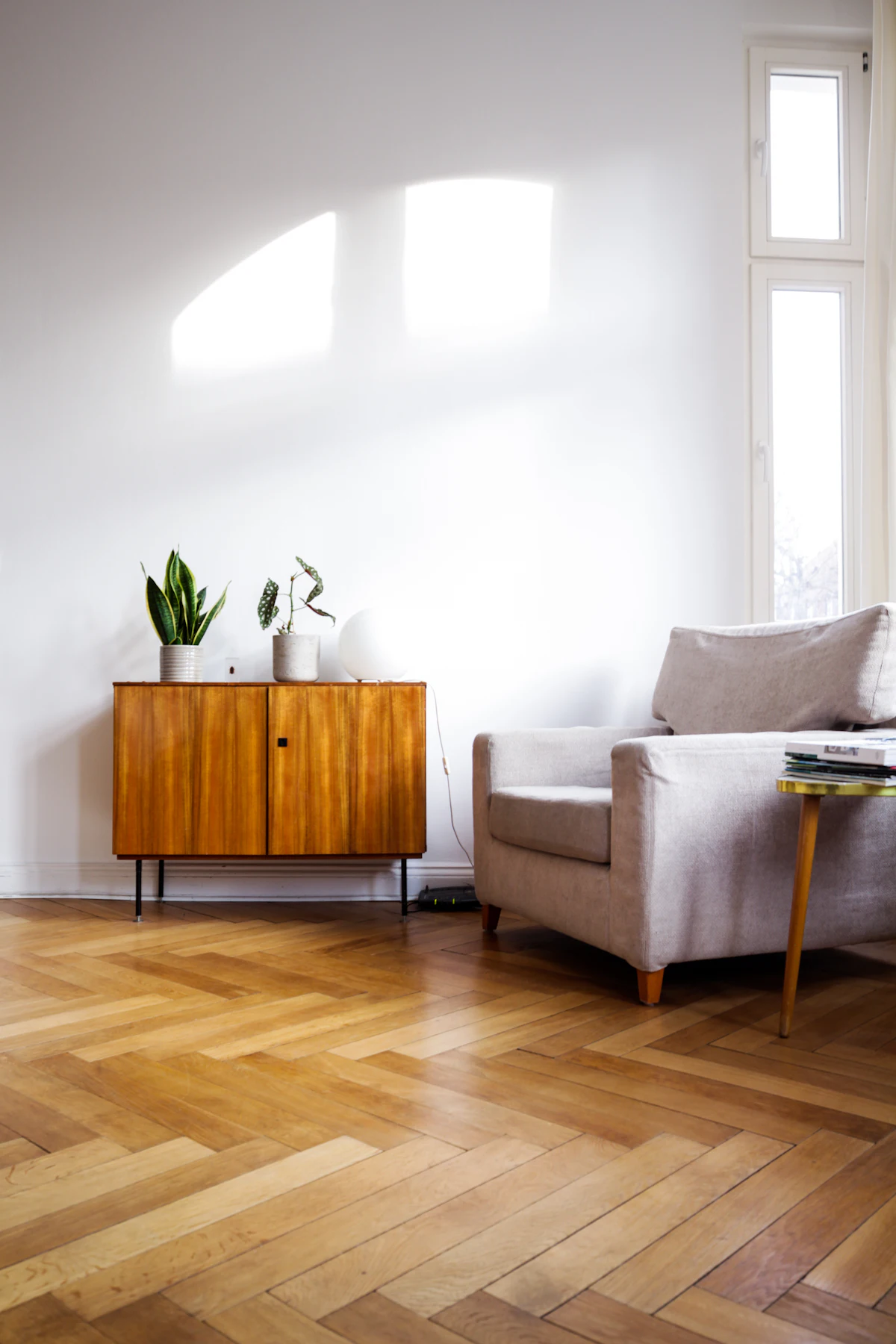 Herringbone wood floor in a bright living space