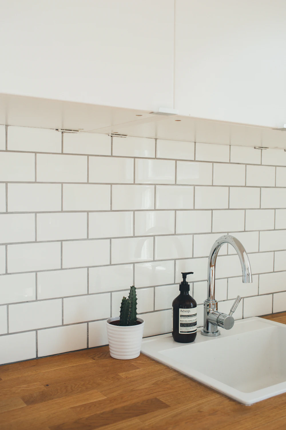 White subway tile backsplash with matte black faucet